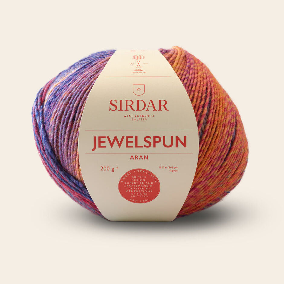Multicolored ball of yarn with Sirdar label on a beige background