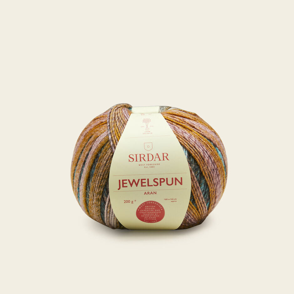 Multicolored ball of yarn with a Sirdar label on a beige background